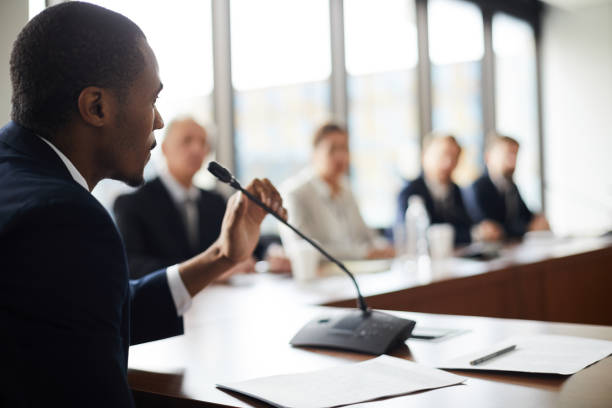 Man giving testimony in a conference room.