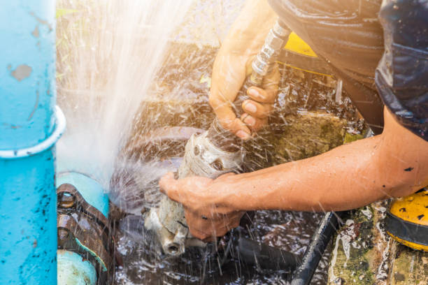 Plumber fixing a broken pipe.